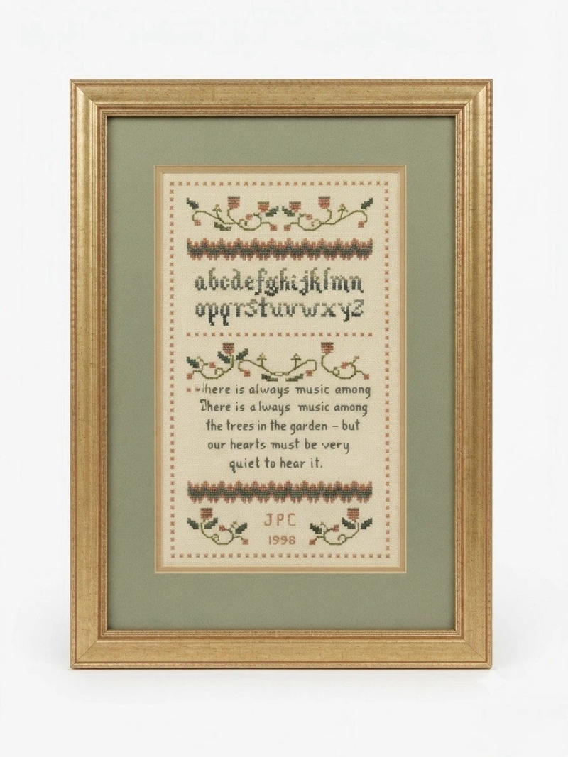 Vintage 1998 cross stitch sampler in gold frame - front view